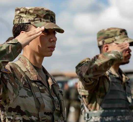 Two people in military uniform in a salute.