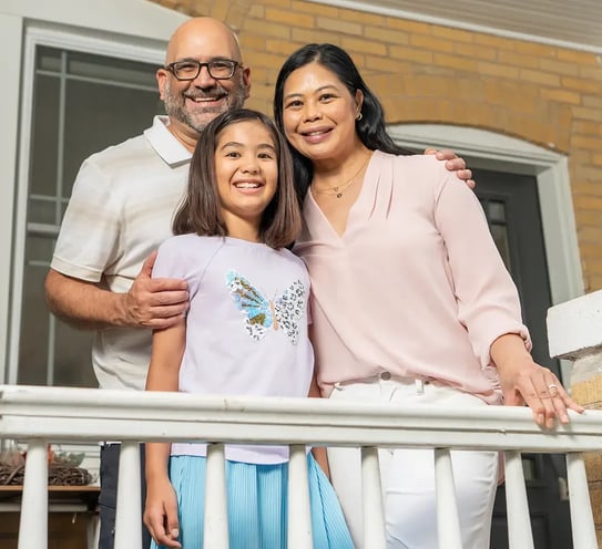 A family standing on a porch.