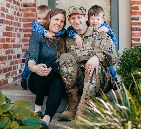 A family sitting on a porch.