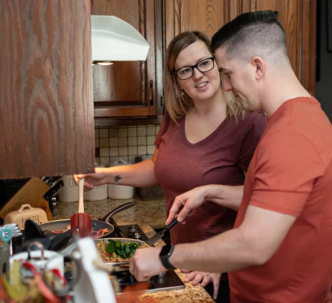 Image of people cooking in a kitchen.