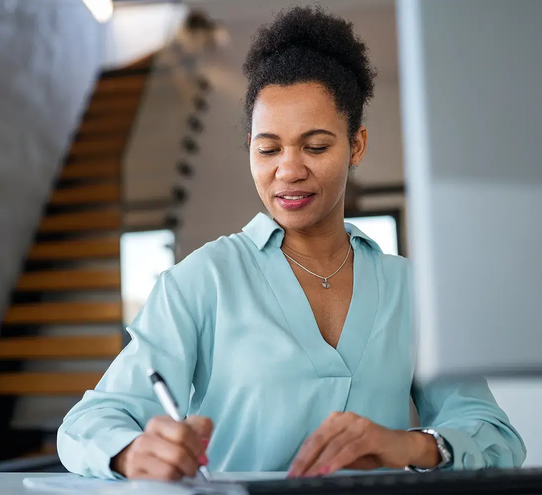 Image of someone filling out paperwork.