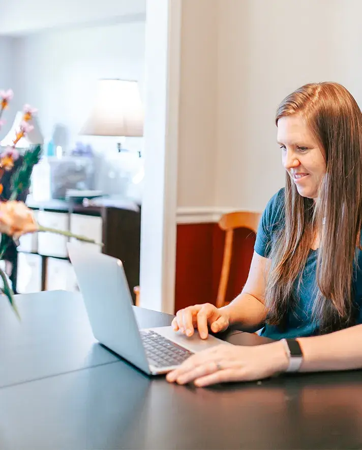 Image of someone sitting at a computer.