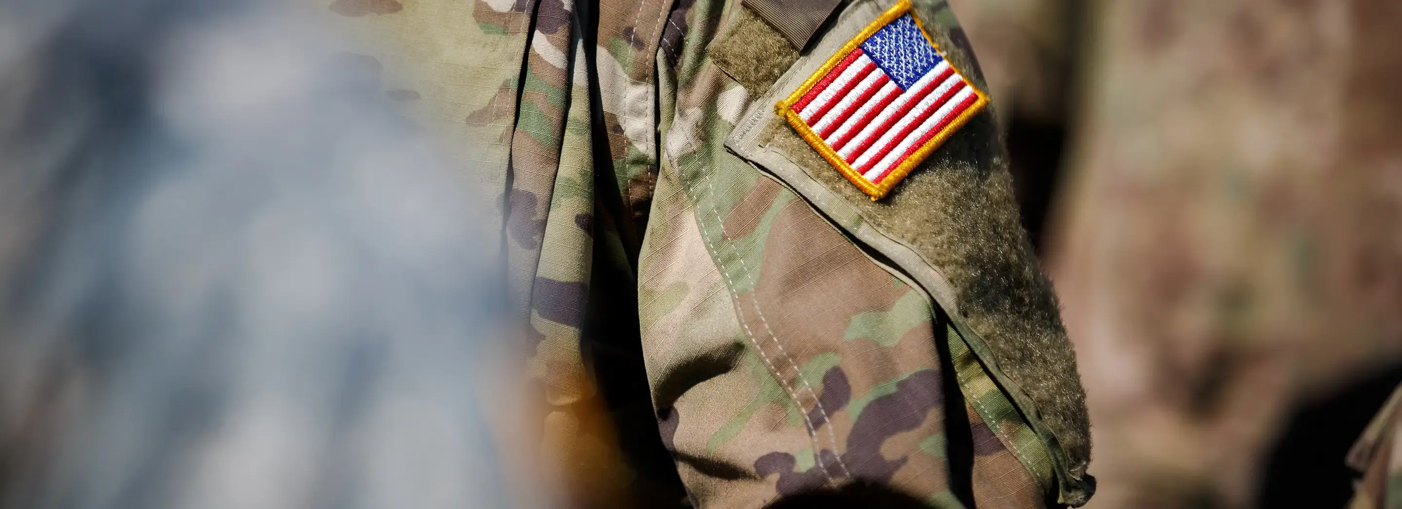 Zoomed in detail of an American Flag patch on a military uniform.