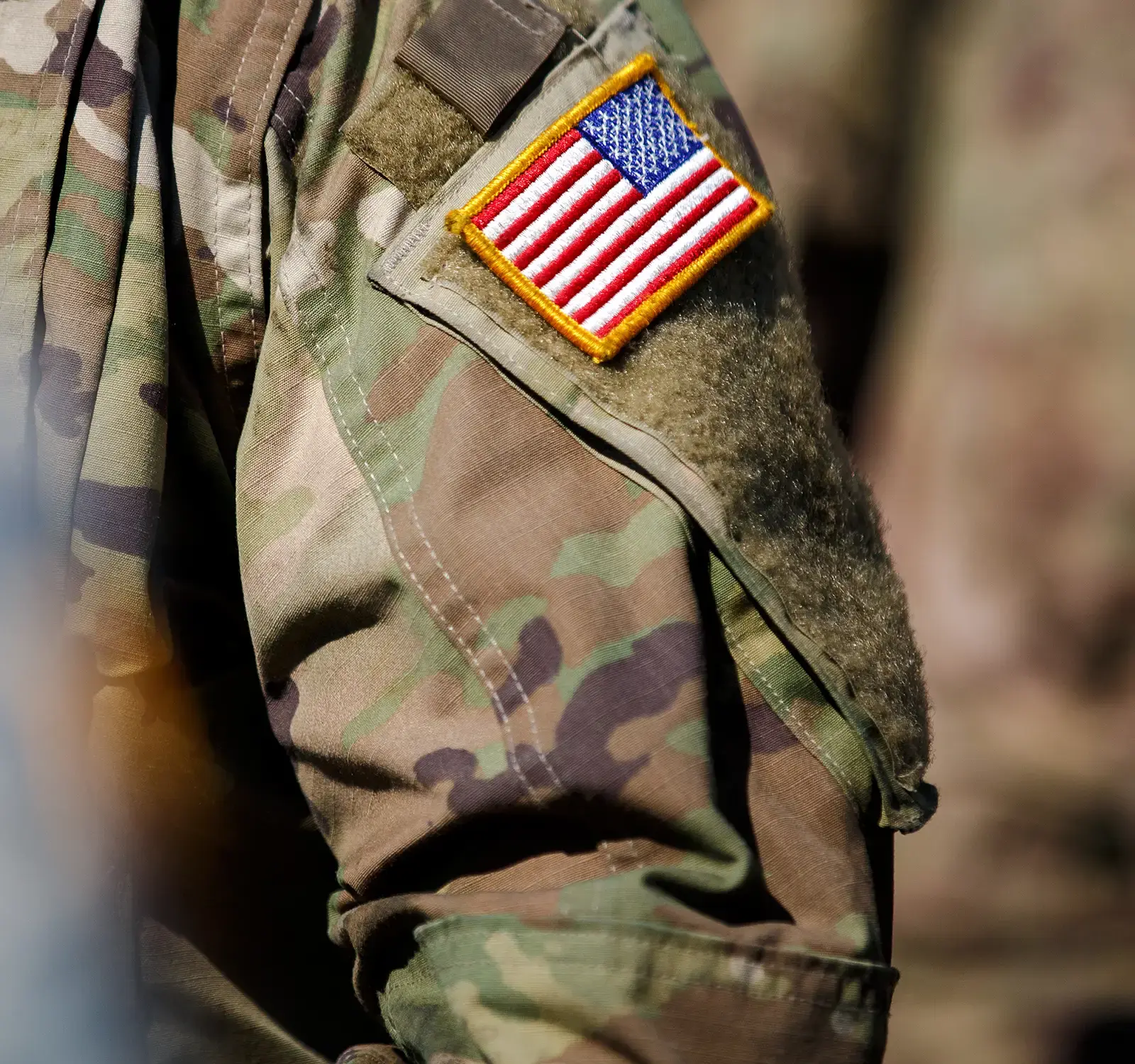 Zoomed in detail of an American Flag patch on a military uniform.