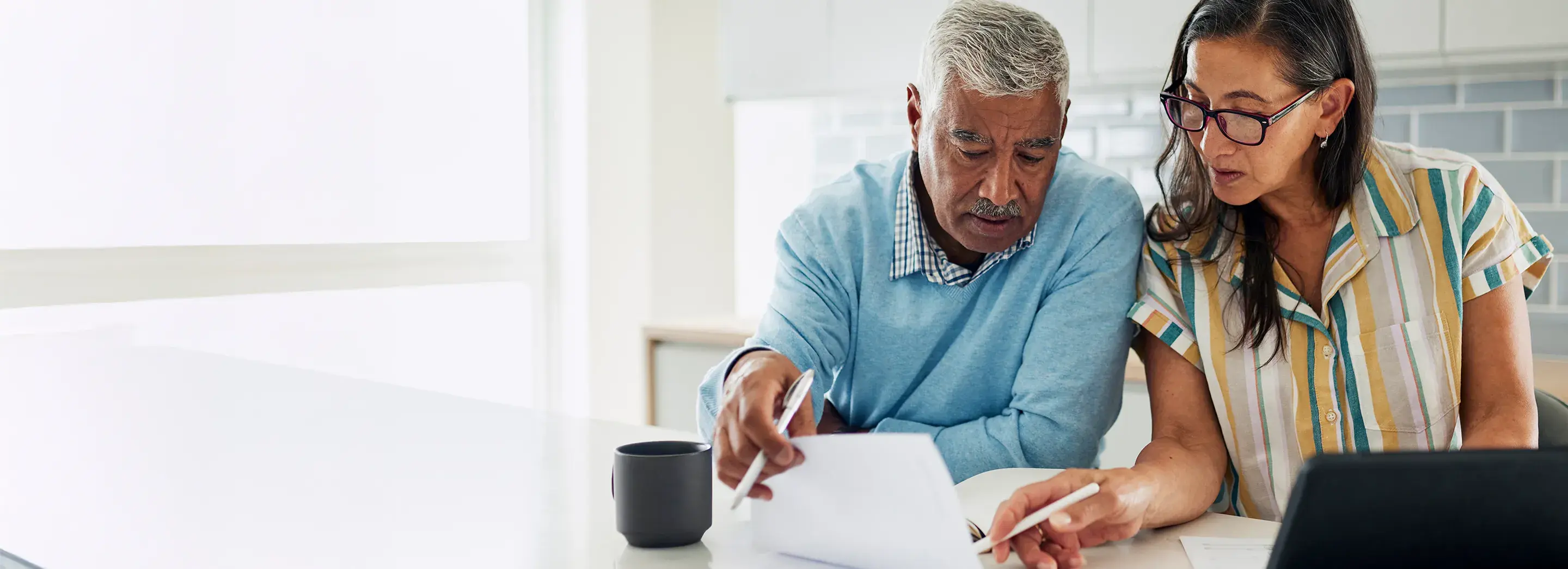 Two people at working at a table.