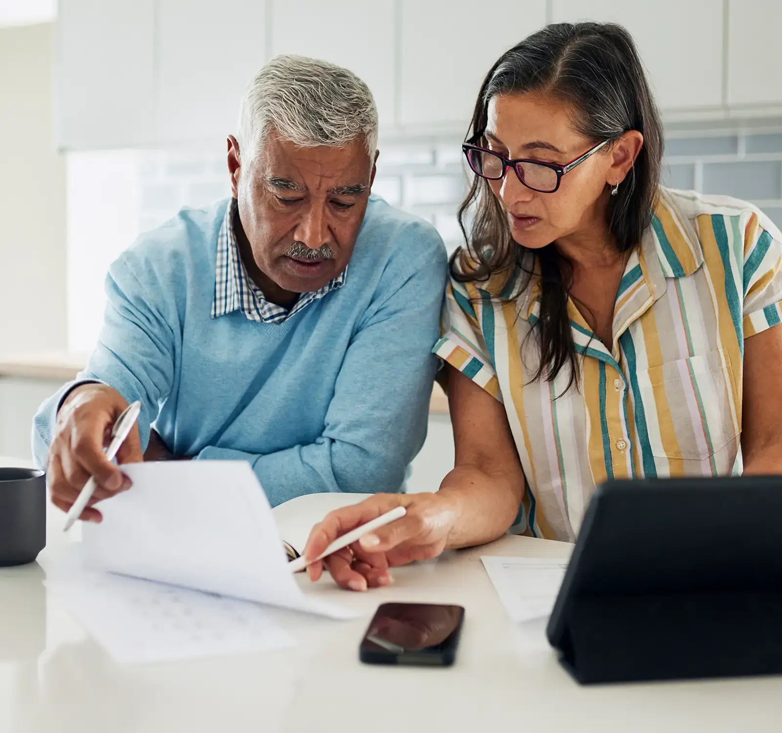 Two people at working at a table.