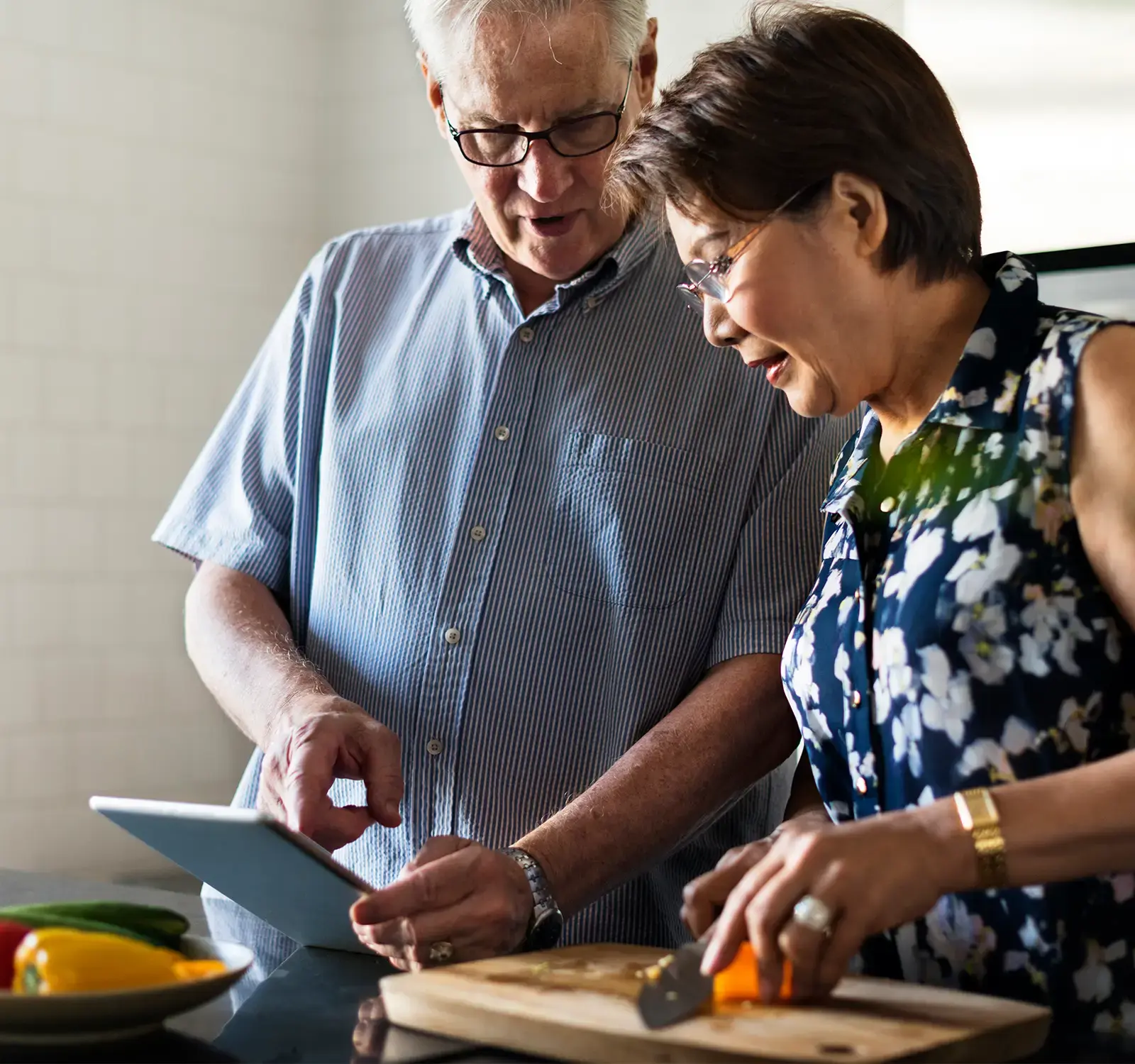 Two People sitting at a table using a computer.