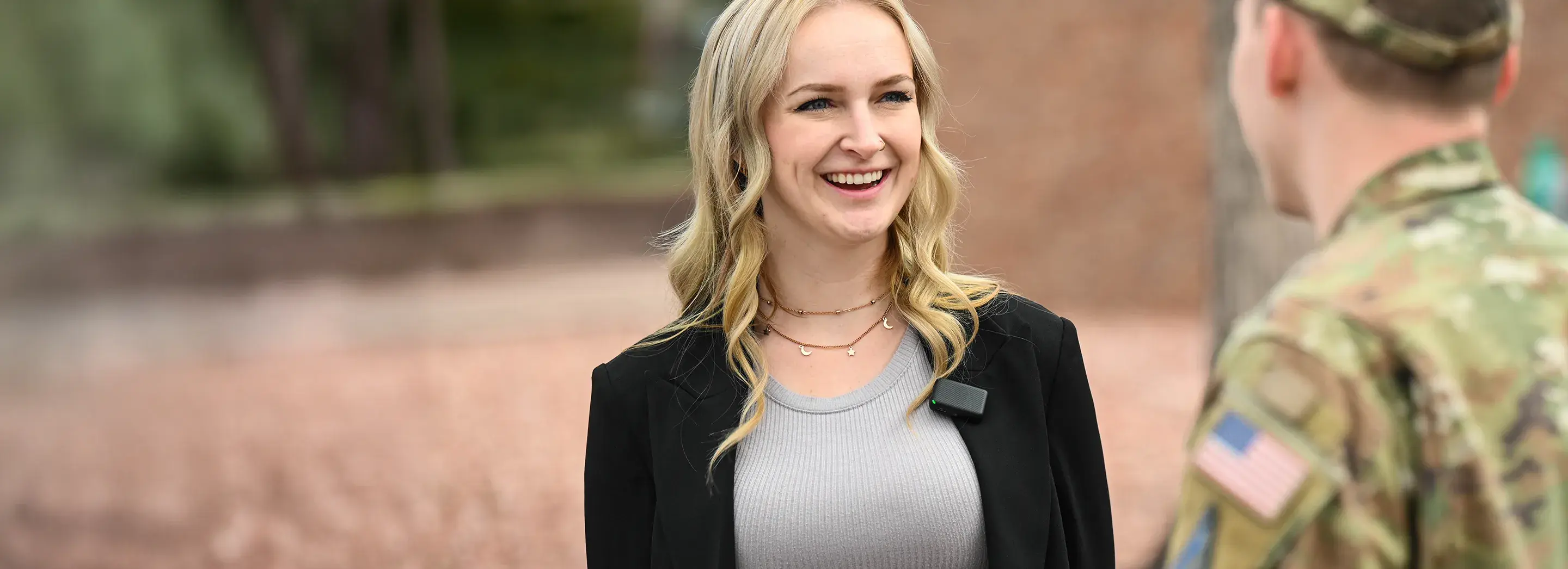 Blonde woman smiling to a soldier