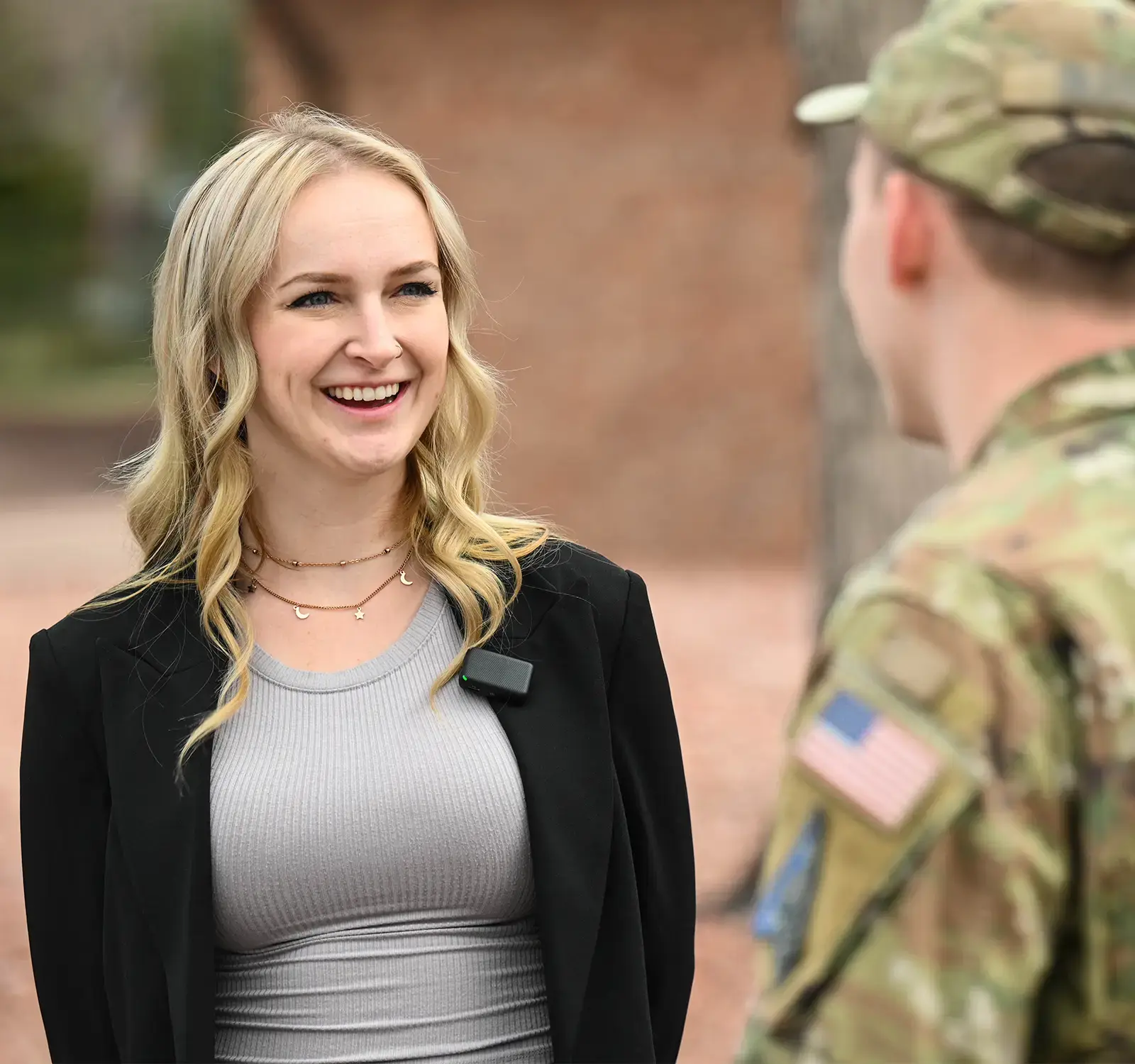 Blonde woman smiling to a soldier