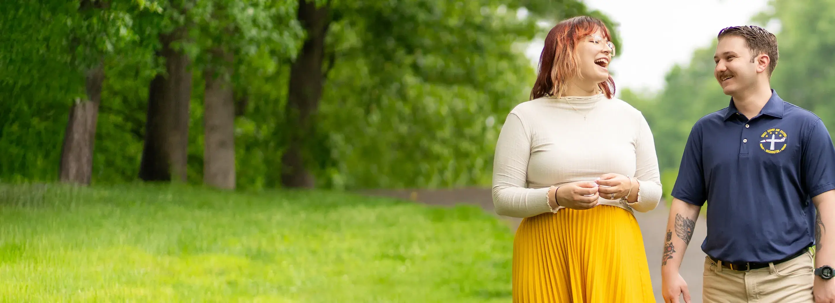 Two people standing in a field.
