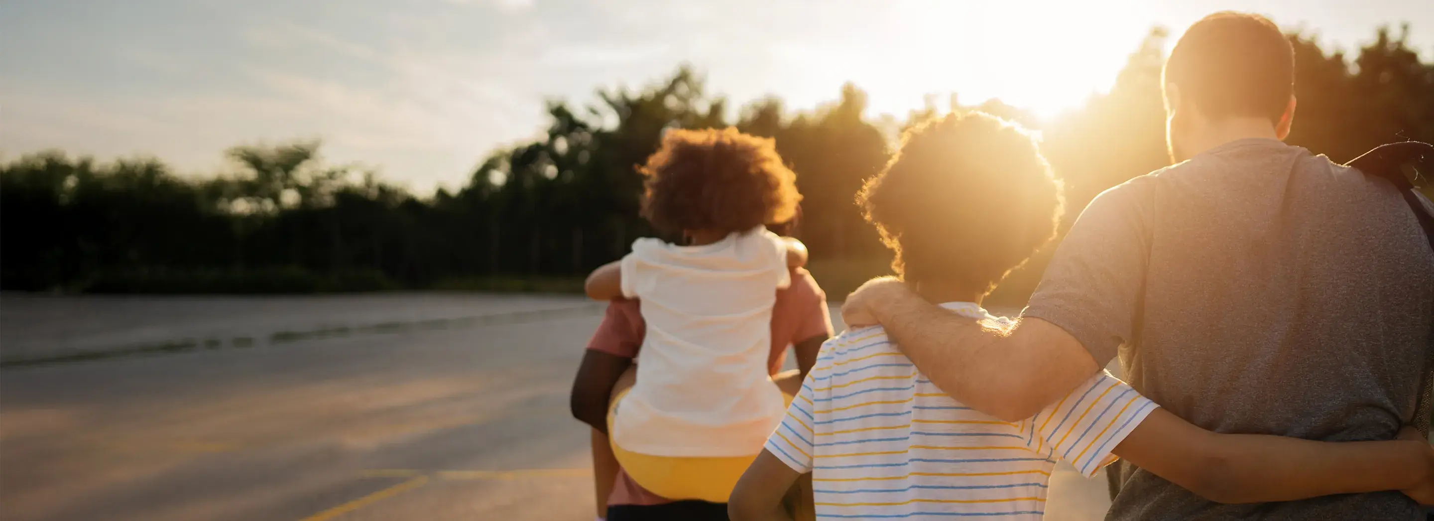 Image of a family walking in the sunset.