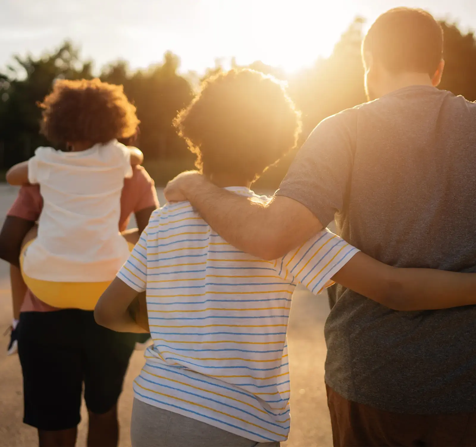 Image of a family walking in the sunset.