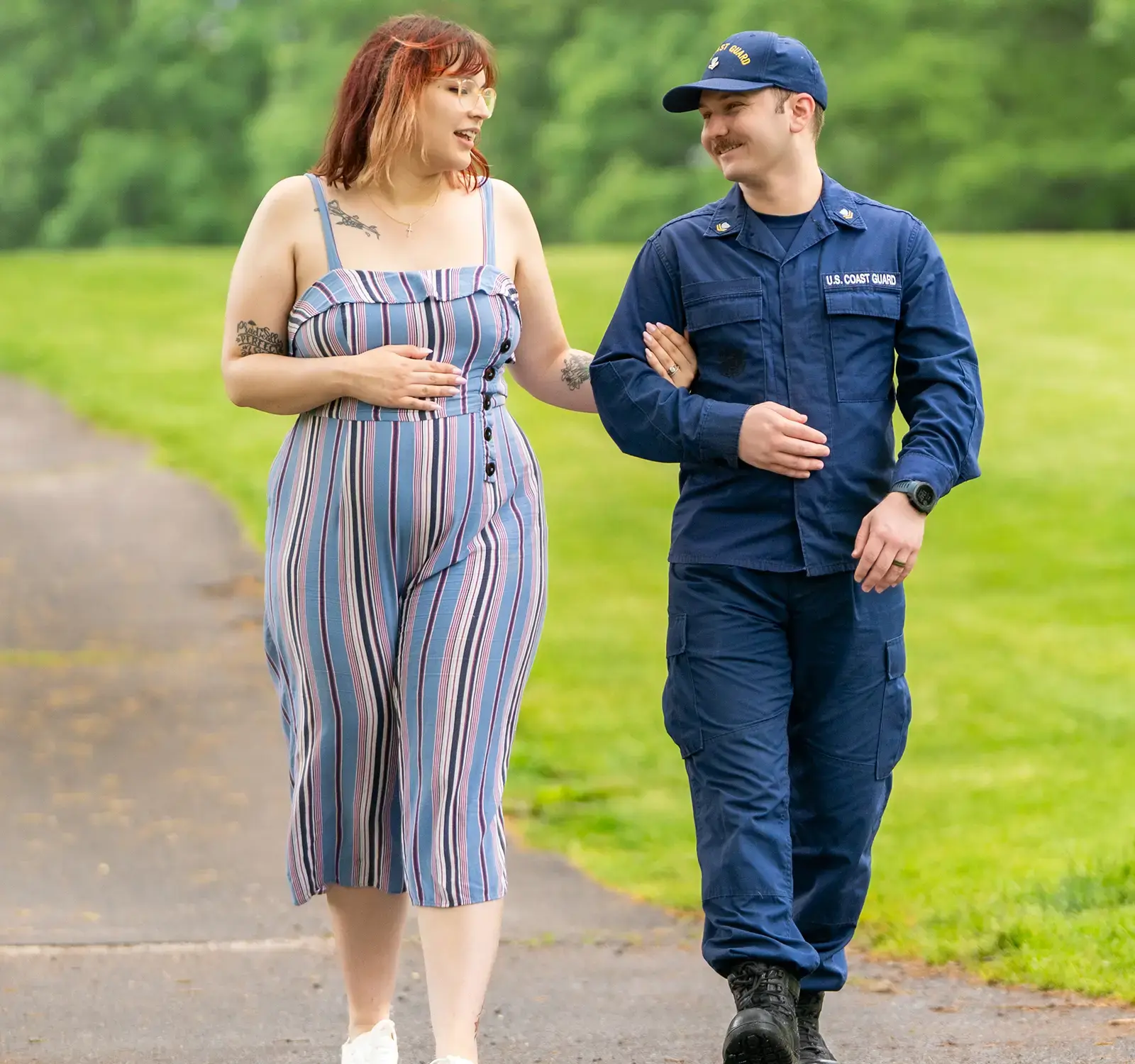 Two people holding hands walking in a park,