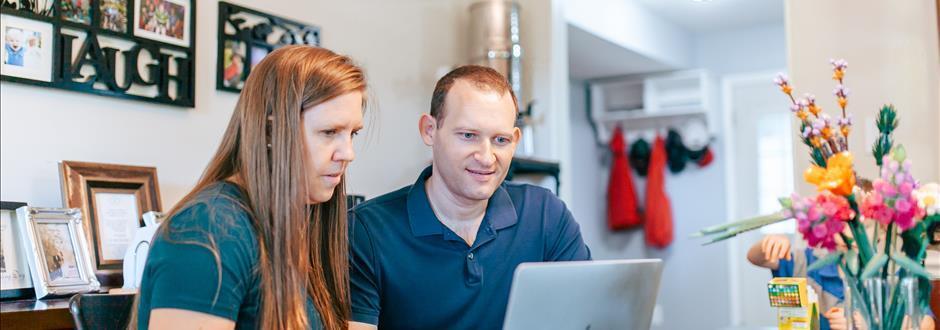 Military couple looking at computer together