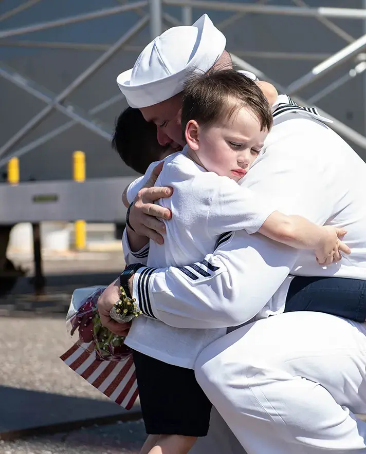 A father hugging children.