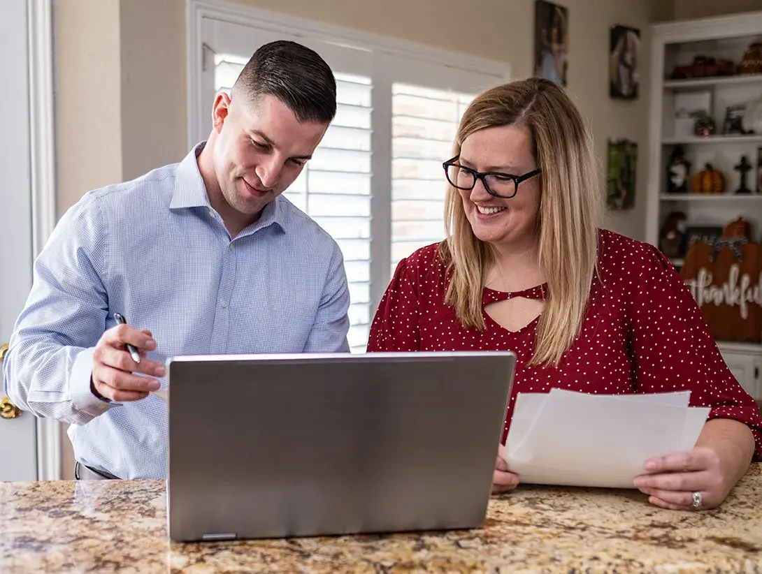 Two people using a laptop.