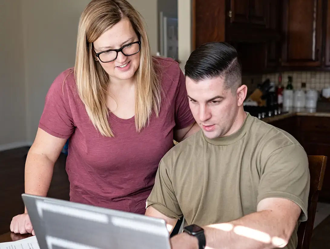 Two people reviewing information that is presented on a computer.