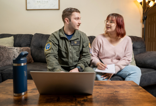Military couple sitting at laptop