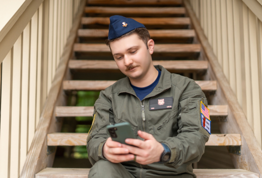 Coast Guard servicemember on his cell phone