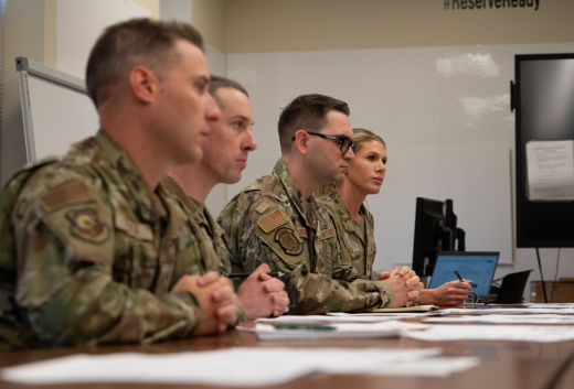 A panel of company grade officers, assigned to the 512th Airlift Wing, evaluate an Airman participating in a mock commissioning board at Dover Air Force Base, Delaware, Nov. 2, 2025. During the day-long event, over a dozen officer candidates had the opportunity to rehearse their answers in a simulated interview. (U.S. Air Force photo by Staff Sgt. Alexis Morris)