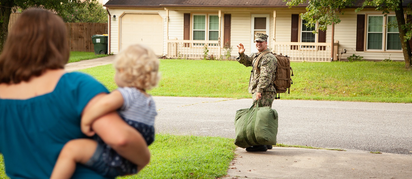 Active navy servicement waving goodbye to his family